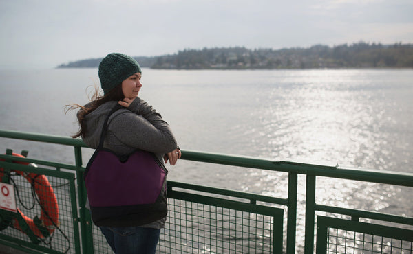 A person on a ferry carrying the Swift over their shoulder.